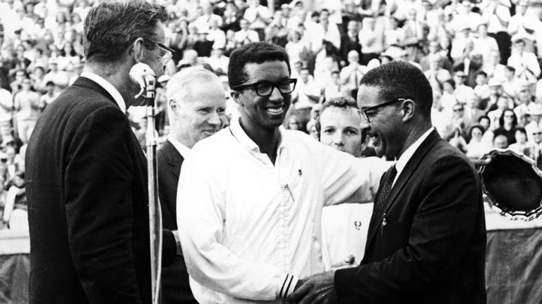 American tennis player Arthur Ashe 1943-1993 is congratulated by his father Arthur Ashe, Sr. at center court at the West Side Tennis Club after winning the first ever US Open in 1968
