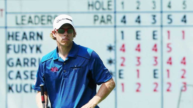 David Hearn's name sits atop the leaderboard as he lines up a par putt at the 18th