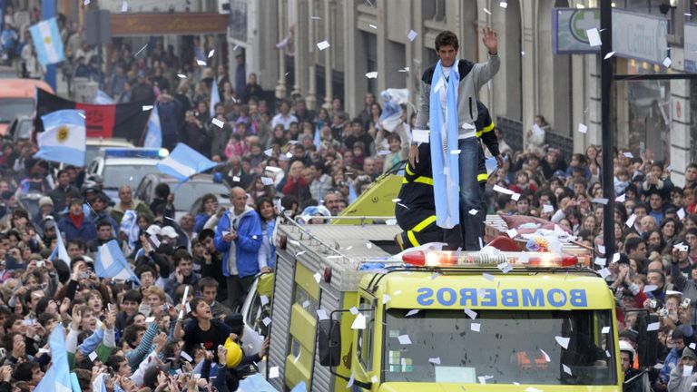 Del Potro waves at people gathered to see him from a fire engine on September 17, 2009, following his arrival in his hometown Tandil
