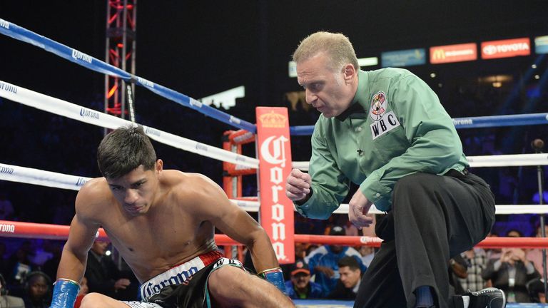 Abner Mares receives a count from referee Jack Reiss before he is knocked out by Jhonny Gonzalez at the StubHub Center