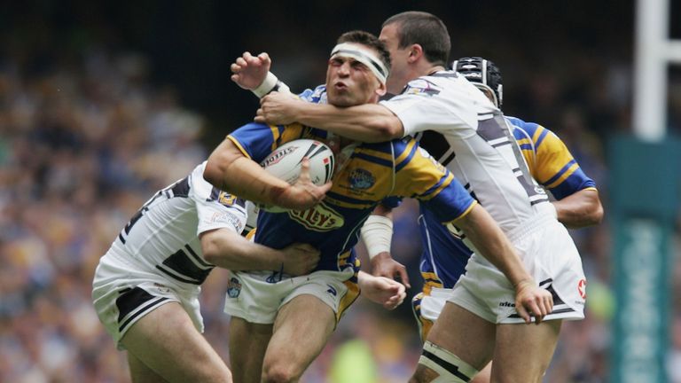 Kevin Sinfield of Leeds takes on Paul Cooke (L) and Chris Chester of Hull during the Powergen Challenge Cup Final between Hull F.C. and Leeds Rhinos at the Millennium Stadium on August 27, 2005 in Cardiff, Wales.