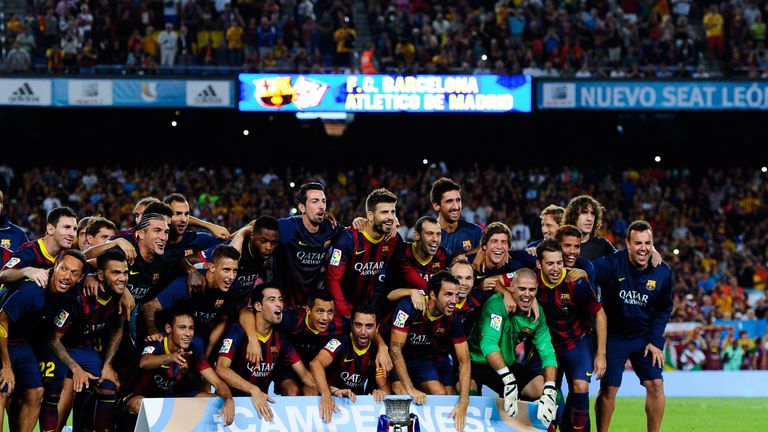 BARCELONA, SPAIN - AUGUST 28:  FC Barcelona players celebrates with the trophy after winning the Spanish Super Cup during the Spanish Super Cup second leg match between FC Barcelona and Atletico de Madrid at Nou Camp on August 28, 2013 in Barcelona, Spain.  (Photo by David Ramos/Getty Images)