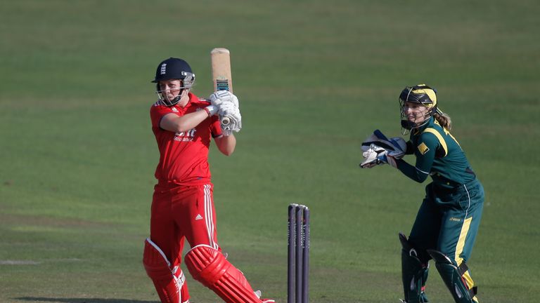 Heather Knight of England hits out watched by Australian wicketkeeper Jodie Fields during the third NatWest One Day International match between England and Australia at the BrightonandHoveJobs.com County Ground on August 25, 2013 in Hove, England