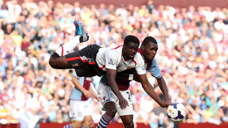 Liverpool's Kolo Toure  and Aston Villa's Christian Benteke battle for the ball