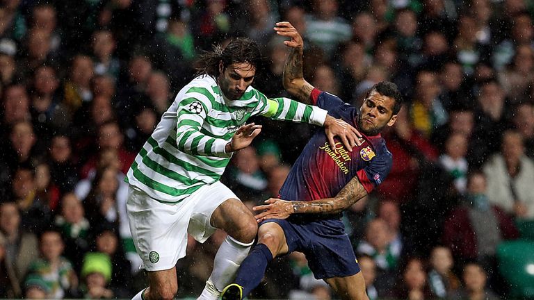 Celtic forward Georgios Samaras competes with Barcelona defender Daniel Alves during their Champions League Group G match at Celtic Park.