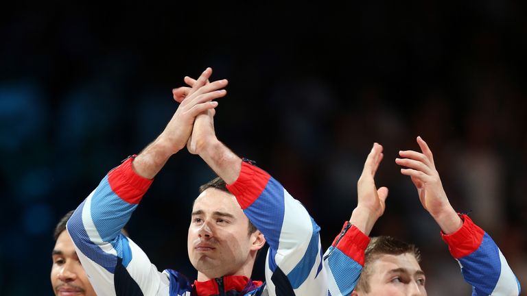 Bronze medalists Louis Smith, Kristian Thomas and Sam Oldham of Great Britain celebrate on the podium during the medal ceremony in the Artistic Gymnastics Men's Team final on Day 3 of the London 2012 Olympic Games at North Greenwich Arena on July 30.