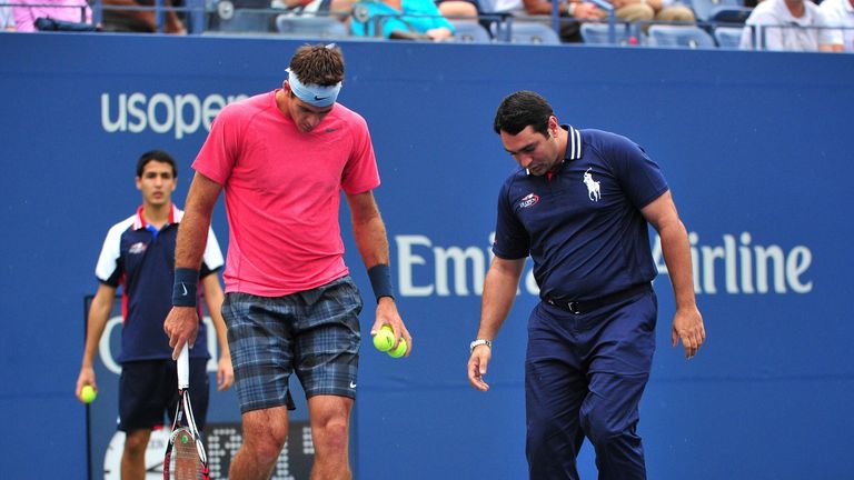 Juan Martin Del Potro of Argentina and the chair umpire check the court as rain falls during the match against Guillermo Garcia-Lopez at the 2013 US Open
