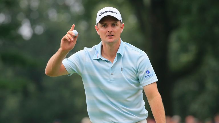 Justin Rose celebrates a birdie during his second round 66