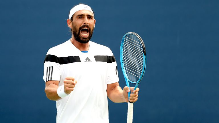 Marcos Baghdatis of Cyprus celebrates a set point during his men's singles first round match against Go Soeda of Japan on Day Three of the 2013 US Open