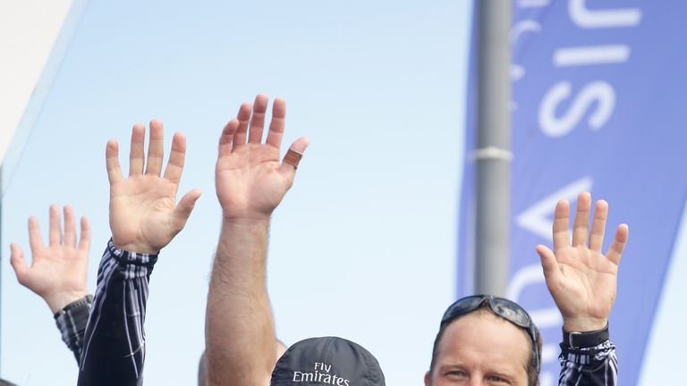 Emirates Team New Zealand managing director Grant Dalton waves to the crowd after they beat Team Luna Rossa Challenge in race eight to win the Louis Vuitton Cup finals on August 25, 2013 in San Francisco