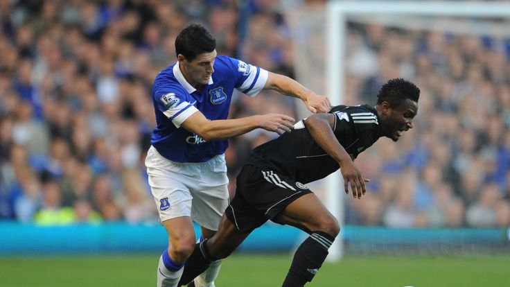 John Obi Mikel of Chelsea tangles with Gareth Barry of Everton  during the Premier League match between Everton and Chelsea at Goodison Park on September 14, 2013 in Liverpool, England. 