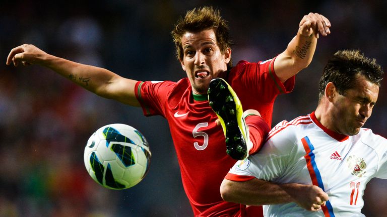 Portugal's defender Fabio Coentrao (L) vies with Russia's Aleksandr Kerzhakov during the World Cup 2014 qualifier football match Portugal vs Russia at Luz Stadium in Lisbon on June 7, 2013.