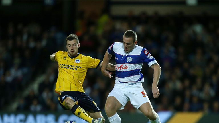 Queens Park Rangers' Richard Dunne (right) and Brighton and Hove Albion's Ashley Barnes battle for possession of the ball during the Sky Bet Championship match at Loftus Road, London.