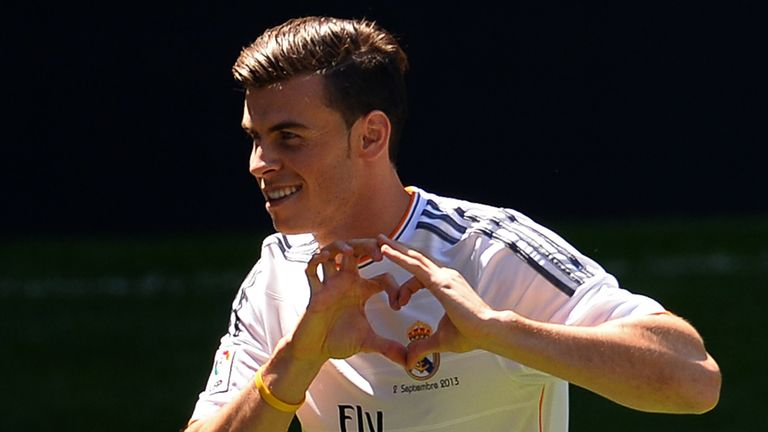 New Welsh striker of Real Madrid Gareth Bale makes a heart sign with his hands during his presentation at the Santiago Bernabeu stadium in Madrid on September 2, 2013.