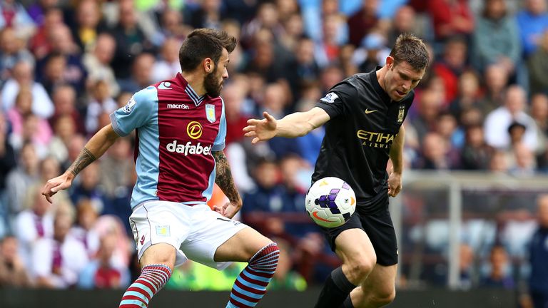 BIRMINGHAM, ENGLAND - SEPTEMBER 28:   James Milner of Manchester City competes with Antonio Luna of Aston Villa during the Barclays Premier League match between Aston Villa and Manchester City at Villa Park on September 28, 2013 in Birmingham, England.  (Photo by Jan Kruger/Getty Images)