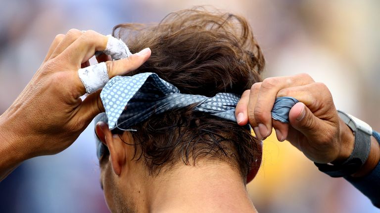 NEW YORK, NY - SEPTEMBER 09:  Rafael Nadal of Spain ties his bandana during a break in his men's singles final match against Novak Djokovic of Serbia on Day Fifteen of the 2013 US Open at the USTA Billie Jean King National Tennis Center on September 9, 2013 in the Flushing neighborhood of the Queens borough of New York City.  (Photo by Al Bello/Getty Images)