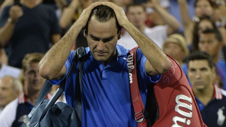 Roger Federer is left dejected by his US Open loss to Tommy Robredo