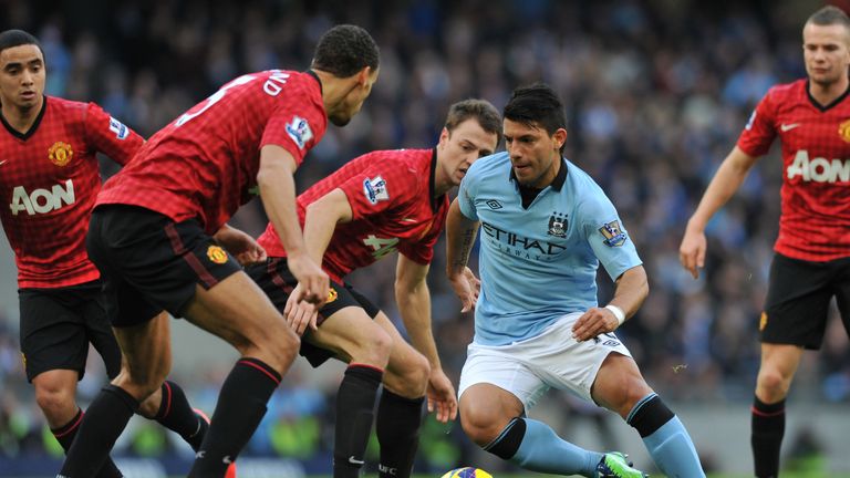 Manchester City's Argentinian striker Sergio Aguero (2nd R) weaves his way through the Manchester United defence during the English Premier League football match between Manchester City and Manchester United at The Etihad stadium in Manchester, north-west England on December 9, 2012. 