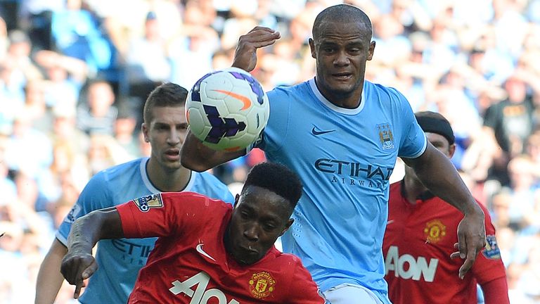 Manchester United's English forward Danny Welbeck (L) vies with Manchester City's Belgian defender Vincent Kompany (R) during the English Premier League football match between Manchester City and Manchester United at the Etihad Stadium in Manchester, northwest England, on September 22, 2013. AFP PHOTO / ANDREW YATESnnRESTRICTED TO EDITORIAL USE. No use with unauthorized audio, video, data, fixture lists, club/league logos or live services. Online in-match use limited to 45 images, no video emulation. No use in betting, games or single club/league/player publications.        (Photo credit should read ANDREW YATES/AFP/Getty Images)