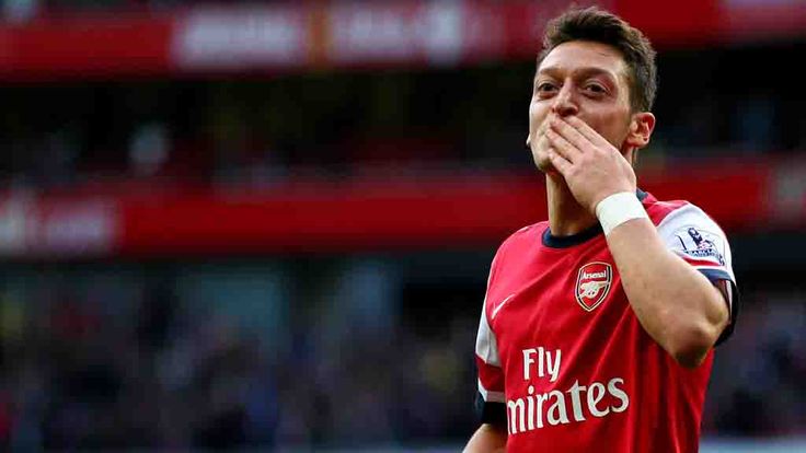 LONDON, ENGLAND - OCTOBER 19:  Mesut Oezil of Arsenal celebrates as he scores their second goal during the Barclays Premier League match between Arsenal and Norwich City at Emirates Stadium on October 19, 2013 in London, England.  (Photo by Paul Gilham/Getty Images)