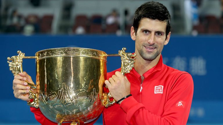 - poses for photographers after defeating Rafael Nadal of Spain during the final of the 2013 China Open