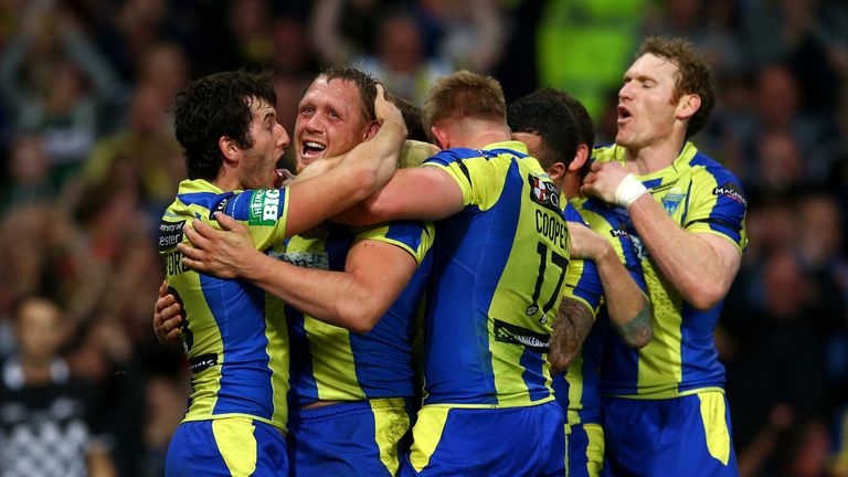 Ben Westwood of Warrington Wolves celebrates with team-mates after scoring his team's third try during the Super League Grand Final against Wigan Warriors
