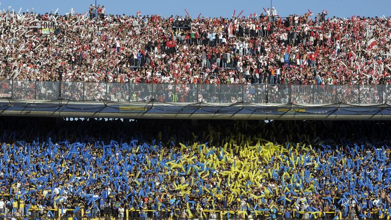 Supporters of Boca Juniors (bottom) and River Plate wait for the start of the Argentine First Division football match at the Bombonera stadium in Buenos Aires, Argentina, on May 5, 2013.  