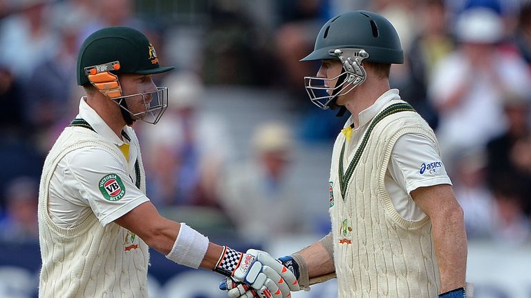 Australia's David Warner (L) shakes hands with Australia's Chris Rogers after reaching 50 runs during the fourth day of the fourth Ashes cricket test match between England and Australia at the Durham cricket ground in Durham, north-east England, on August 12, 2013