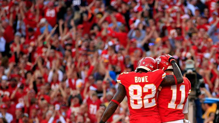 Wide receiver Dwayne Bowe #82 of the Kansas City Chiefs congratulates quarterback Alex Smith #11 after Smith carried the ball into the endzone for a touchdown during the 1st half of the game against the Houston Texans at Arrowhead Stadium on October 20, 2013 in Kansas City, Missouri.  