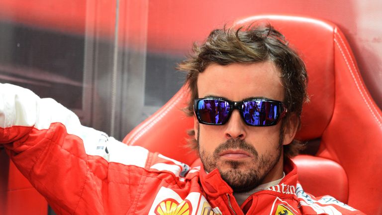 Fernando Alonso waits in the garage