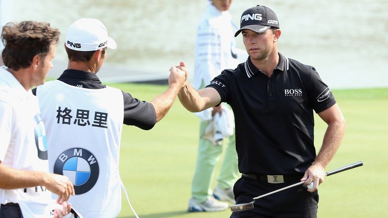 Luke Guthrie celebrates with his caddie after his opening 65 at the BMW Masters