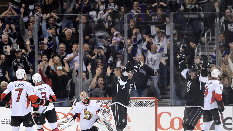 Jeff Carter #77 of the Los Angeles Kings celebrates his game winning goal with Anze Kopitar #11 in front of Craig Anderson #41 of the Ottawa Senators to win 4-3 in overtime at Staples Center on October 9, 2013 in Los Angeles, California. 
