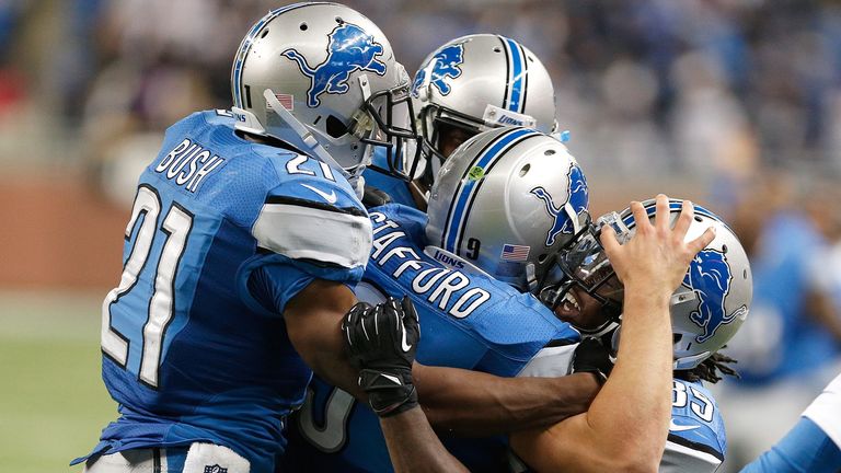 Matthew Stafford #9 of the Detroit Lions celebrates his game winning touchdown with Joique Bell #35 and Reggie Bush #21