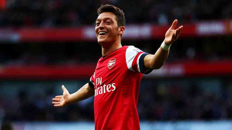 LONDON, ENGLAND - OCTOBER 19:  Mesut Oezil of Arsenal celebrates as he scores their second goal during the Barclays Premier League match between Arsenal and Norwich City at Emirates Stadium on October 19, 2013 in London, England.  (Photo by Paul Gilham/Getty Images)