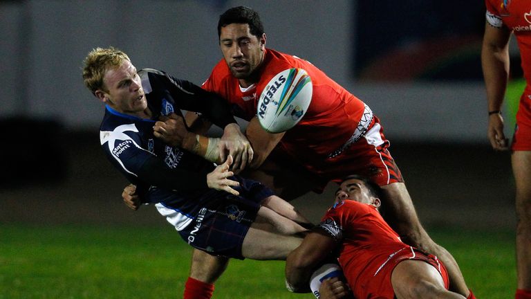 Peter Wallace of Scotland is tackled by Brent Kite and Nafe Seluini of Tonga during the Rugby League World Cup Group C match in Workington