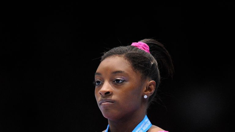 World Championship gold medallist US gymnast Simone Biles celebrates on the podium of the all-around final