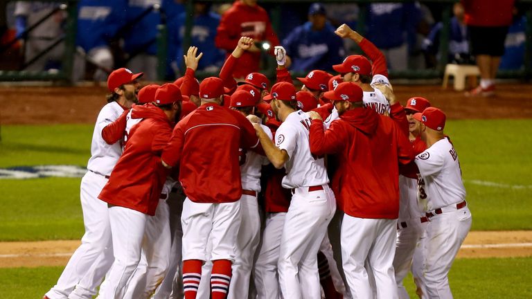 The St. Louis Cardinals celebrate after defeating the Los Angeles Dodgers 9-0 to make the World Series