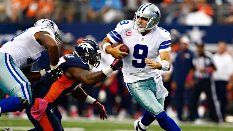 Tony Romo of the Dallas Cowboys scrambles to avoid the rush during a game against the Denver Broncos