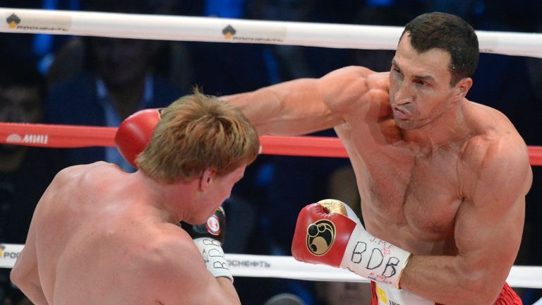 Wladimir Klitschko (R) punches Alexander Povetkin during their fight in Moscow on October 5, 2013.