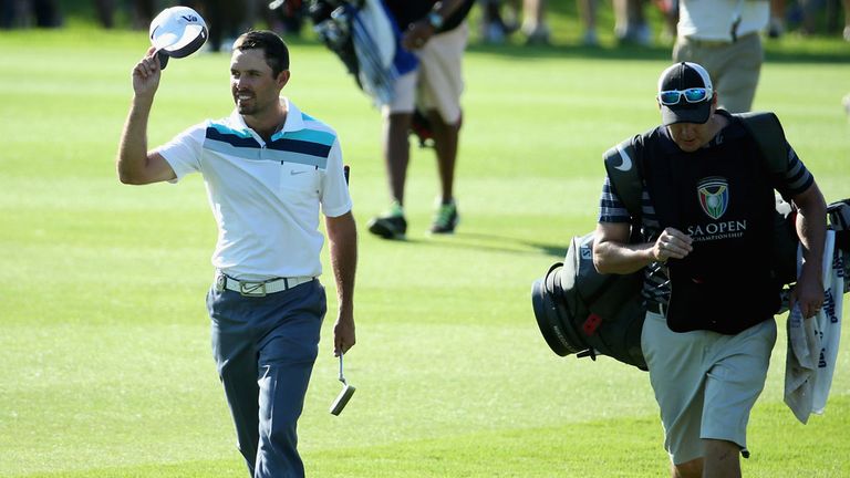 Charl Schwartzel acknowledges the home crowd as he wanders up the 18th fairway on Saturday