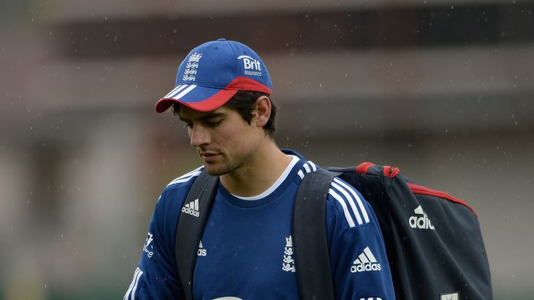England captain Alastair Cook walks back to the dressing room as rain delays the start of day three of the tour match between Australia A and England at Blundstone Arena on November 8, 2013 in Hobart, Australia. 