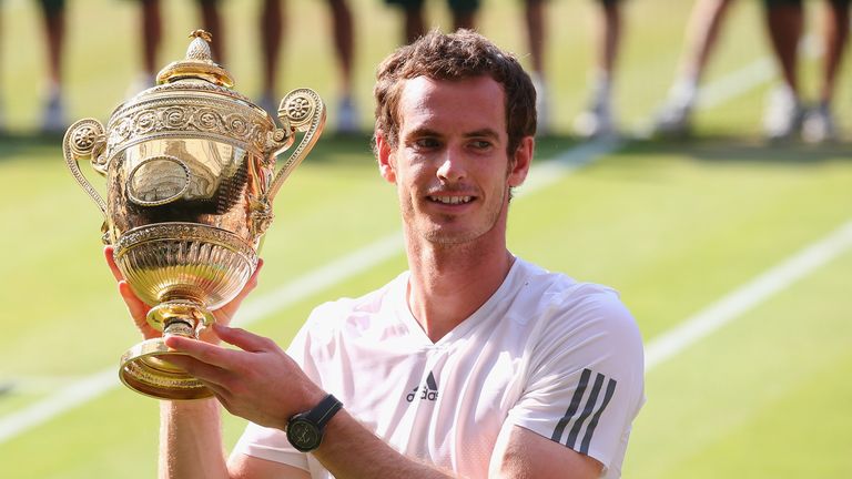 Andy Murray poses with the trophy following his 2013 Wimbledon victory over Novak Djokovic