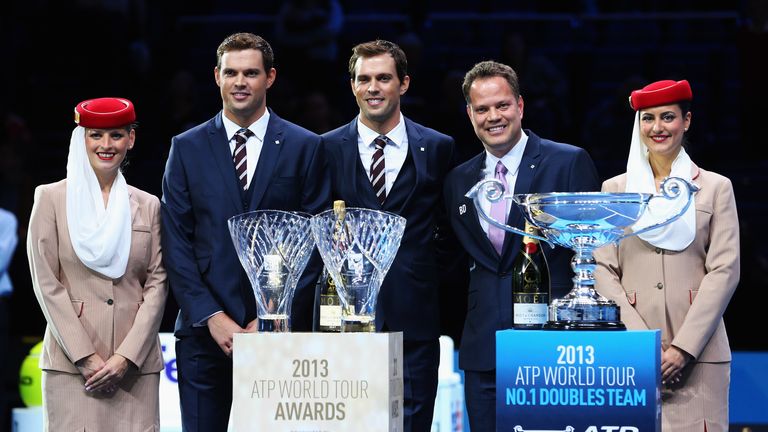 Bob and Mike Bryan of the United States pose with their ATPWorldTour.com Fans' Favourite award and the ATP World Tour No. 1 Doubles Team trophy, presented by Andre Silva (2ndR), Barclays ATP World Tour Finals Tournament Director during day five of the Barclays ATP World Tour Finals at O2 Arena on November 8, 2013 in London, England.