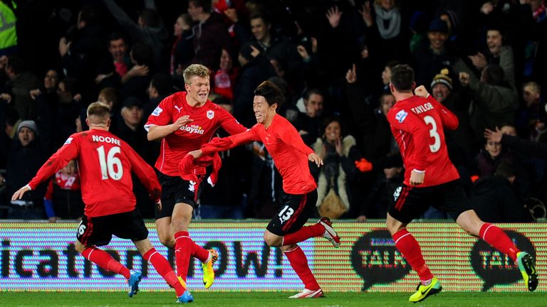 Kim Bo-Kyung of Cardiff celebrates with team-mates after scoring equaliser v Manchester United at Cardiff City Stadium
