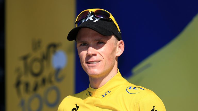 Chris Froome of Great Britain and Team Sky Procycling celebrates on the podium as he secures the leader's yellow jersey after stage twenty of the 2013 Tour de France, a 125KM road stage from Annecy to Annecy-Semnoz, on July 20, 2013 in Annecy, France
