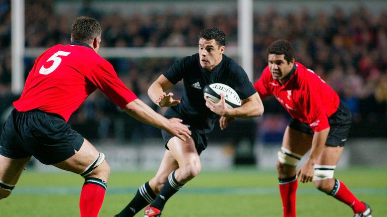 Daniel Carter #12 of the All Blacks runs between Gareth Llewellyn #5 and Colin Charvis during the test match between the New Zealand All Blacks and Wales at Waikato Stadium June 21, 2003 in Hamilton, New Zealand. The All Blacks won the match 55 - 3. (Photo by Dean Treml/Getty Images)