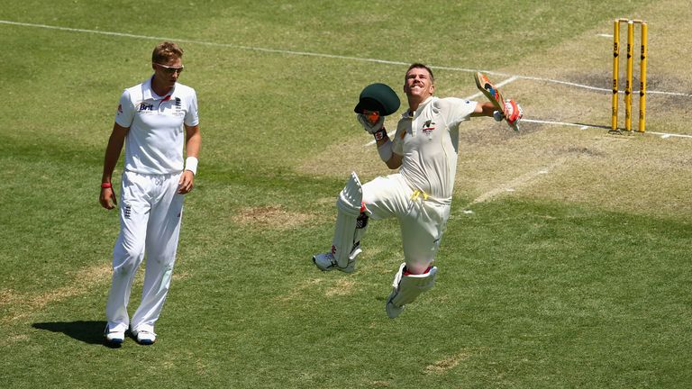 David Warner of Australia celebrates after reaching his century as Joe Root of England looks on during day three of the First Ashes Test match between Australia and England at The Gabba on November 23, 2013 in Brisbane, Australia