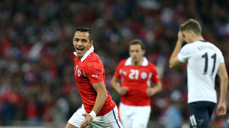 Chile's Alexis Sanchez celebrates scoring their first goal of the game as England's Jay Rodriguez (right) stands dejected