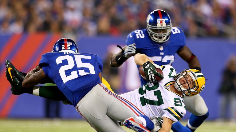 Jordy Nelson #87 of the Green Bay Packers collides with Will Hill #25 of the New York Giants as  Jon Beason #52 of the Giants stands by in the second half at MetLife Stadium on November 17, 2013 in East Rutherford, New Jersey.The New York Giants defeated the Green Bay Packers 27-13