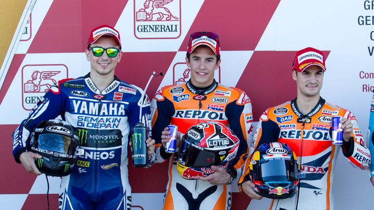 Repsol Honda Team's Spanish rider Marc Marquez (C),  Yamaha Factory Racing's Spanish rider Jorge Lorenzo (L) and Repsol Honda Team's Spanish rider Dani Pedrosa pose after the Moto GP qualification at Ricardo Tormo racetrack in Cheste, near Valencia, on November 9, 2013.